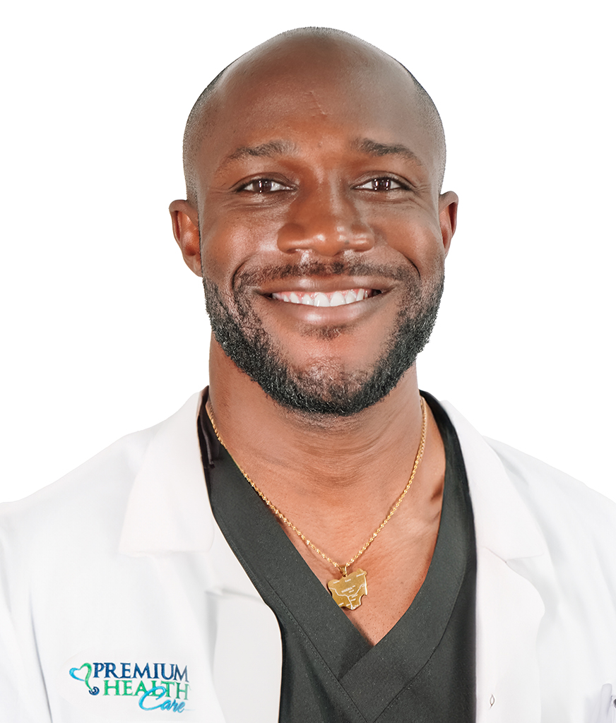 Doctor Bamidele Olupona dressed in a white coat smiling at the camera