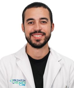 Picture of Genial Diaz smiling and staring at camera wearing a white coat.