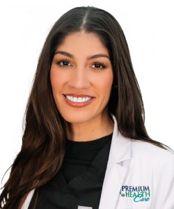 Picture of Yaneysis hernandez from premium healthcare wearing a white coat and smiling at camera.