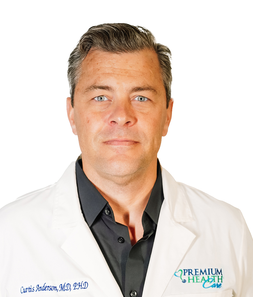 Doctor Curtis Anderson in a white coat starting at the camera