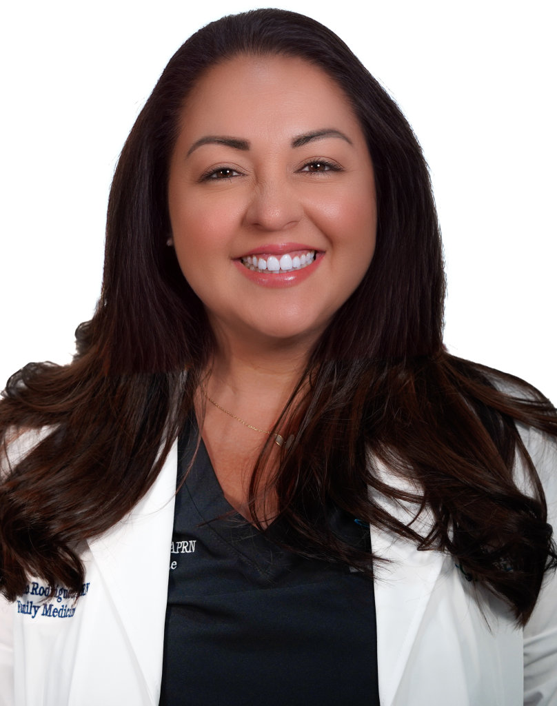 Consuelo Rodriguez APRN smiling at camera in a white coat.