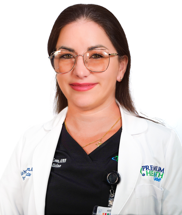 Lesliet Ponce De Leon APRN in a white coat smiling at the camera wearing glasses.